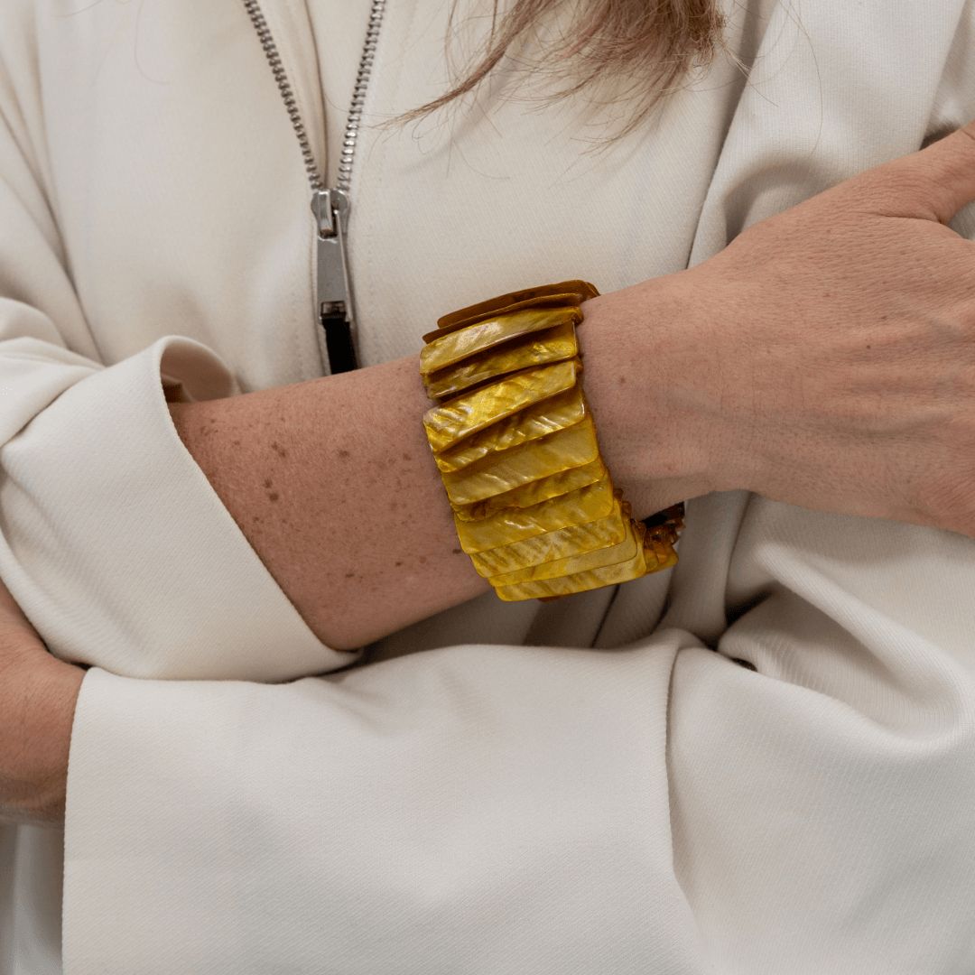 Brede goudbruine parelmoer armband Honey Shell gedragen om de pols